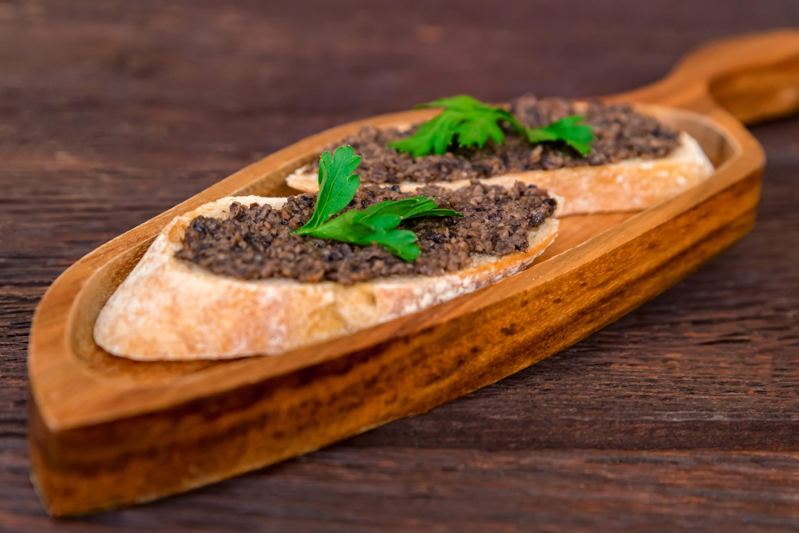 Fresh tasty bruschetta with truffle sauce and parsley